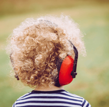 Child wearing noise-canceling headphones to support sensory regulation and ADHD calm-down strategies