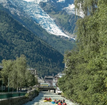 a group of people rafting down a river in chamonix
