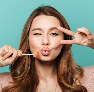 a woman with a pink lippy and a lollipop in her mouth