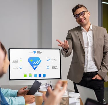 a man in a suit and glasses is standing in front of a computer screen presenting logo design