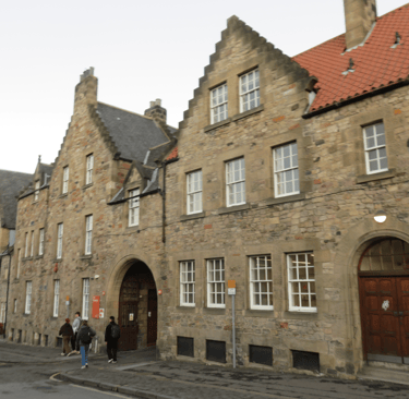 The entrance to the Pleasance Courtyard, through an archway in an old stone building.