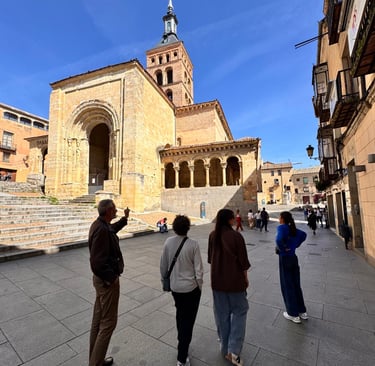 Host explaining the history to a private group tour in front of a medieval church