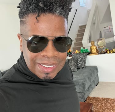 a man with a black hair and sunglasses