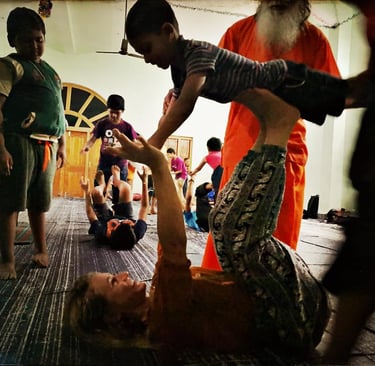 a woman is doing a acroyoga with a kid