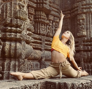 a woman in a yellow shirt is doing yoga in India