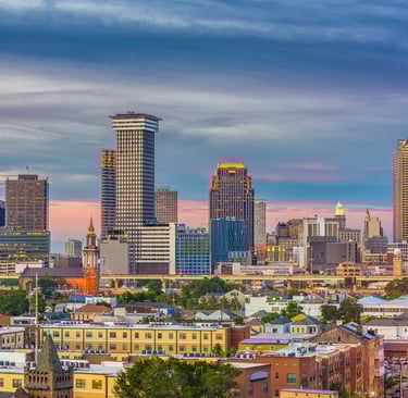 a city skyline with tall buildings and a clock tower
