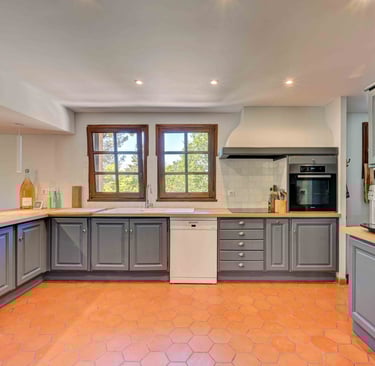 a kitchen with a tile floor and a large window
