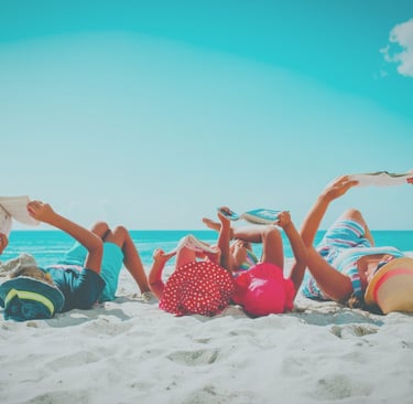 SWB Global Academy  Nurturing Curious Minds  Individualized Learning | Family reading on a beach