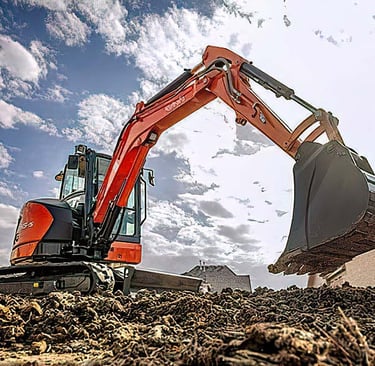 Excavator digging at a construction site, showing the benefits of renting construction equipment