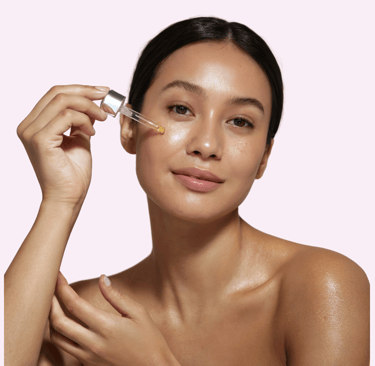 a woman applying serum on her face