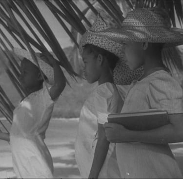 Black and white photo of three Mauritian children in straw hats by the beach, Cape Town Photography Festival 2025.