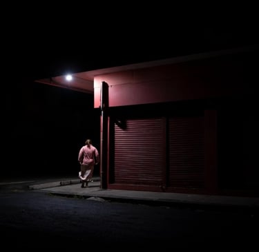 Person walking under streetlight at night in Mauritius, Cape Town Photography Festival 2025.