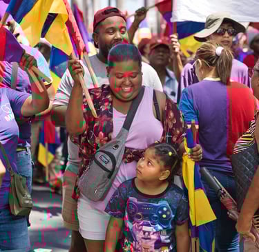Smiling family in the crowd holding flags