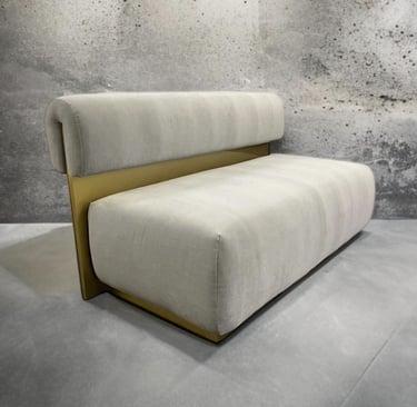 Modern bench with plush cream cushions and gold metal back, by Solo Home Decor.