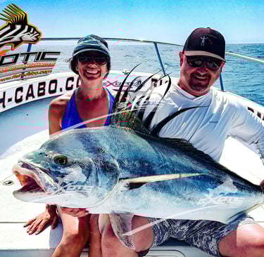 a man and woman holding a fish on a boat