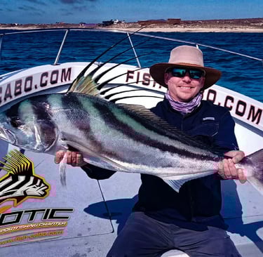 a man in a hat and sunglasses holding a fish