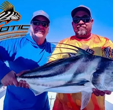 two men holding a fish on a boat