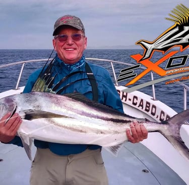 a man holding a fish on a boat