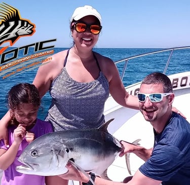 a woman and two children are holding a fish