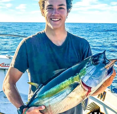 a man holding a fish on a boat