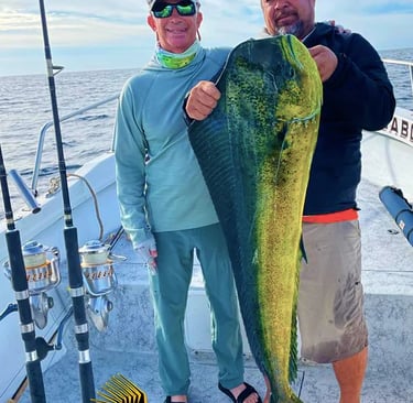 a man holding a fish on a boat