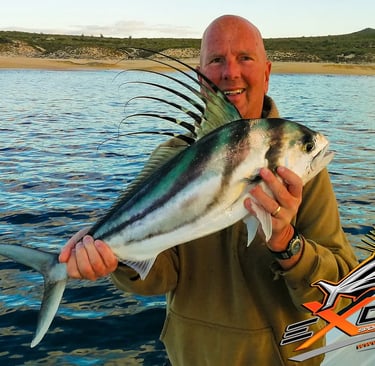 a man holding a fish fish on a boat