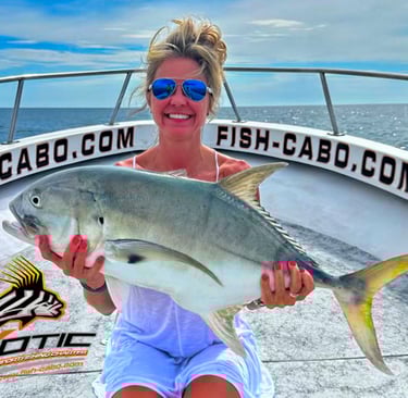 a woman holding a fish fish on a boat