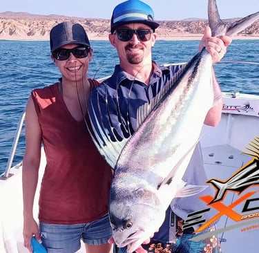 a man and woman holding a fish fish