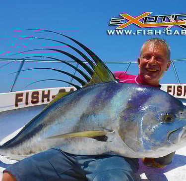 a man holding a fish on a boat