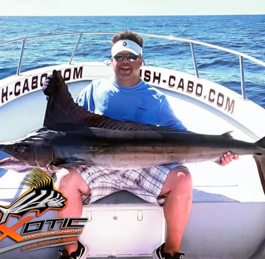 a man holding a fish on a boat