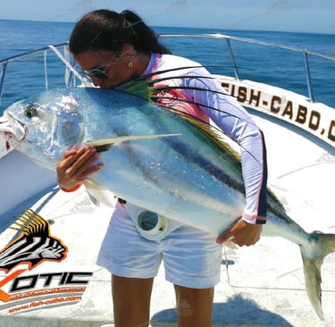 a woman holding a fish fish on a boat
