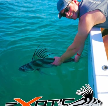 a man is holding a fish in the water