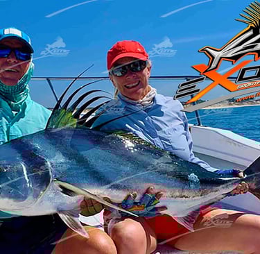 two people holding a fish on a boat