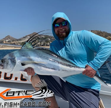 a man holding a fish fish on a boat