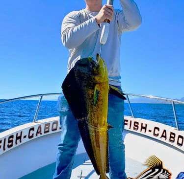 a man holding a fish caught fish on a boat
