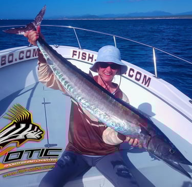 a man holding a fish fish on a boat
