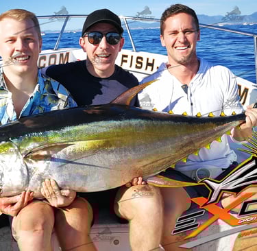 three men sitting on a boat with a big fish