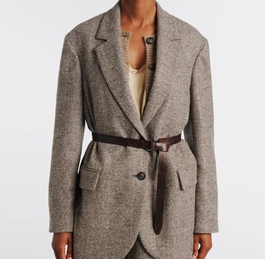 a model in a trench coat with a belt