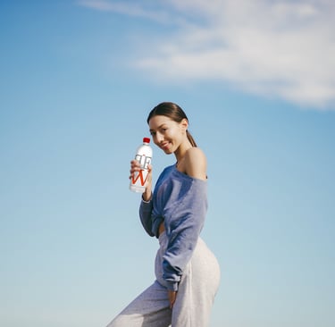 agua alcalina: mujer sosteniendo una botella