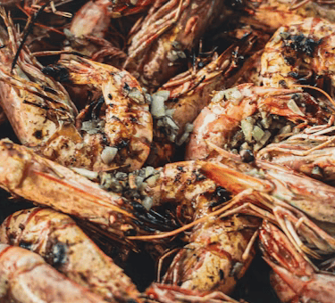 grilled shrimp in a pot with seasoning