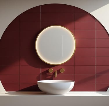 Ruby red bathroom wall with white sink, round mirror, and modern gold fixtures.