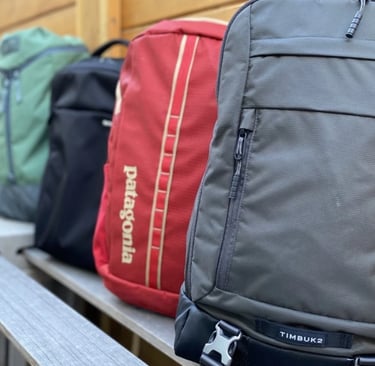 lightweight waterproof travel backpack for hiking and city bunch of backpacks lined up on a bench