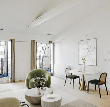 a living room with a table and chairs