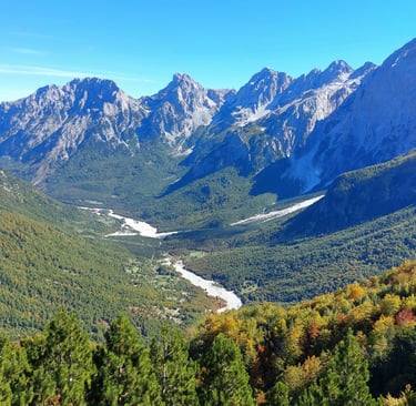 a mountain view of a valley with a river running through it