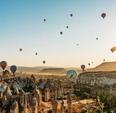 a bunch of balloons are flying in the sky