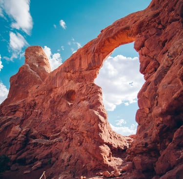 a large arch shaped rock formation in the desert