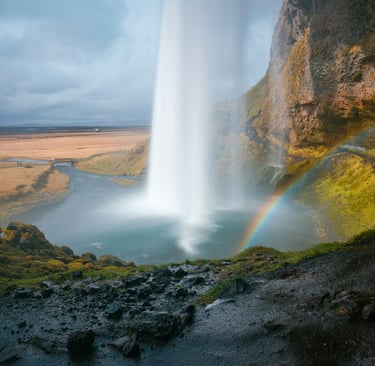 a rainbow over a waterfall