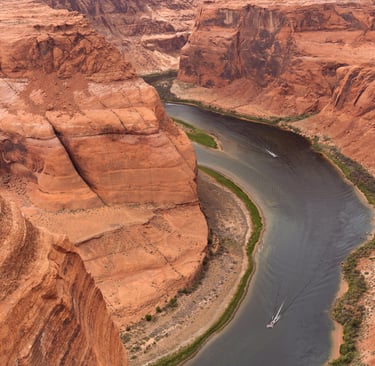 a boat is sailing on the river in the desert