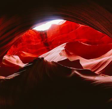 a large red rock formation in the middle of a canyon