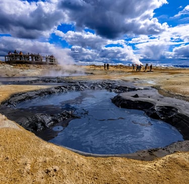 people standing around a small volcano pool